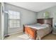 Bedroom with a wooden bed frame, carpet flooring, and a window with blinds at 9329 Wellstone Dr, Land O Lakes, FL 34638