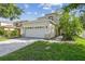 Charming two-story home with a two-car garage, manicured lawn, and inviting curb appeal at 9329 Wellstone Dr, Land O Lakes, FL 34638