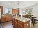 Open kitchen with granite countertops, stainless steel appliances, and a central island with seating at 9329 Wellstone Dr, Land O Lakes, FL 34638