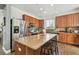 Spacious kitchen with an island, granite countertops, and stainless steel appliances at 9329 Wellstone Dr, Land O Lakes, FL 34638