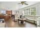 Open concept living room features lots of natural light and wood-look tile flooring at 9329 Wellstone Dr, Land O Lakes, FL 34638