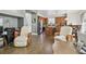 Open concept living room into the kitchen offering wood-look flooring throughout the home at 9329 Wellstone Dr, Land O Lakes, FL 34638