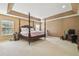 A spacious main bedroom offering tray ceilings and large windows at 9329 Wellstone Dr, Land O Lakes, FL 34638