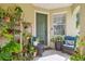 Cozy front porch with potted plants and comfortable seating, perfect for relaxing outdoors at 9329 Wellstone Dr, Land O Lakes, FL 34638