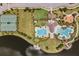 An aerial view of the community amenities including a resort-style pool, clubhouse, tennis courts and playground by the lake at 9839 Lemon Drop Loop, Sun City Center, FL 33573
