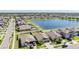 Enjoy the serene view of this community, where homes line the street with a lake in the background at 9839 Lemon Drop Loop, Sun City Center, FL 33573