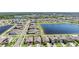 An aerial view of a lakeside residential community; perfect for families looking for a peaceful neighborhood at 9839 Lemon Drop Loop, Sun City Center, FL 33573