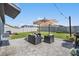 Inviting backyard with a paved patio area, comfortable seating, and a neatly manicured lawn at 9839 Lemon Drop Loop, Sun City Center, FL 33573