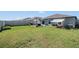 Spacious backyard with a patio, outdoor seating, and a well-kept lawn at 9839 Lemon Drop Loop, Sun City Center, FL 33573