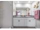 Bathroom featuring double vanity with granite counters and tiled shower at 9839 Lemon Drop Loop, Sun City Center, FL 33573
