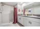 Bathroom featuring double vanity with granite counters and tiled shower at 9839 Lemon Drop Loop, Sun City Center, FL 33573