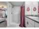 Bathroom featuring double vanity with granite counters and tiled shower at 9839 Lemon Drop Loop, Sun City Center, FL 33573