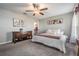 Bright bedroom with soft carpet, accent wall, bed and wooden cabinet at 9839 Lemon Drop Loop, Sun City Center, FL 33573