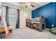 Playful bedroom with bunk bed, neutral colors and blue accent wall at 9839 Lemon Drop Loop, Sun City Center, FL 33573