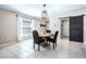 Cozy dining area featuring a round wooden table, modern lighting, and a decorative sliding barn door at 9839 Lemon Drop Loop, Sun City Center, FL 33573