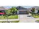 Charming single-Gathering home with a manicured lawn and a two-car garage and landscaping at 9839 Lemon Drop Loop, Sun City Center, FL 33573