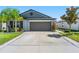 Charming single-story home featuring a two-car garage, landscaped yard, and well-maintained lawn at 9839 Lemon Drop Loop, Sun City Center, FL 33573