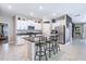 Modern kitchen features white cabinetry, granite countertops, stainless steel appliances, and a breakfast bar at 9839 Lemon Drop Loop, Sun City Center, FL 33573