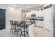 Bright kitchen with granite countertops, stainless steel appliances, island with seating at 9839 Lemon Drop Loop, Sun City Center, FL 33573