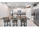 Kitchen featuring granite countertops, stainless steel appliances, and an island with barstool seating at 9839 Lemon Drop Loop, Sun City Center, FL 33573