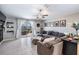 Comfortable living room with ample seating, neutral decor, and sliding glass doors leading to the outdoor space at 9839 Lemon Drop Loop, Sun City Center, FL 33573