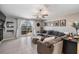 Comfortable living room with gray sectional, neutral walls and sliding door to the patio at 9839 Lemon Drop Loop, Sun City Center, FL 33573