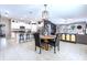 Bright open floor plan features a modern kitchen with stainless steel appliances, adjacent to dining and living areas at 9839 Lemon Drop Loop, Sun City Center, FL 33573