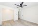 Bright bedroom with light hardwood floors, ceiling fan, and closet ready for comfort at 1008 Shangri La Dr, Seffner, FL 33584