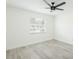 This bedroom features light, neutral walls, light wood-look floors and a ceiling fan at 1008 Shangri La Dr, Seffner, FL 33584