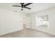 Bright bedroom with ceiling fan, wood-look floors, and a large window with natural light at 1008 Shangri La Dr, Seffner, FL 33584