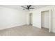 This bedroom features light, neutral walls and light wood-look floors and ceiling fan at 1008 Shangri La Dr, Seffner, FL 33584