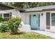 Inviting front entrance featuring a stylish aqua-colored door and a well-maintained brick facade at 1008 Shangri La Dr, Seffner, FL 33584