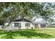 A beautiful single story home with a two car garage and a large, shade tree at 1008 Shangri La Dr, Seffner, FL 33584