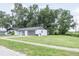 Charming single-story home featuring a well-manicured lawn and a two-car garage at 1008 Shangri La Dr, Seffner, FL 33584