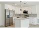 Modern kitchen with stainless steel appliances, white cabinetry, and a quartz-topped kitchen island at 1008 Shangri La Dr, Seffner, FL 33584