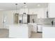 Modern kitchen showcasing white cabinets, stainless steel appliances, quartz countertops, and tile backsplash at 1008 Shangri La Dr, Seffner, FL 33584