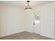 Neutral space with hardwood floors and a new white door leading to the backyard at 1008 Shangri La Dr, Seffner, FL 33584