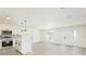 Bright and airy living room with hardwood floors seamlessly open to a modern kitchen area at 1008 Shangri La Dr, Seffner, FL 33584