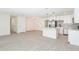 Spacious open-concept design with hardwood floors, connecting to a modern kitchen and neutral walls at 1008 Shangri La Dr, Seffner, FL 33584
