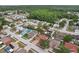 Aerial view of homes in a tree-lined neighborhood with a large nature preserve at 10304 Rainbow Oaks Dr, Hudson, FL 34667