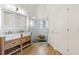 Bright bathroom features a double sink vanity, custom wood cabinet, and glass shower at 10304 Rainbow Oaks Dr, Hudson, FL 34667