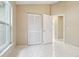 This bedroom features a closet, tile floors, and access to the bathroom at 10304 Rainbow Oaks Dr, Hudson, FL 34667
