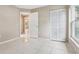 This bedroom features a closet, tile floors, and access to another room at 10304 Rainbow Oaks Dr, Hudson, FL 34667