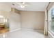 Spacious bedroom featuring tile flooring, a ceiling fan, and a bright window at 10304 Rainbow Oaks Dr, Hudson, FL 34667