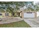 Charming single-story home featuring a well-manicured lawn and a two-car garage at 10304 Rainbow Oaks Dr, Hudson, FL 34667