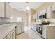 The kitchen features stainless appliances, white cabinets, and a view from the window at 10304 Rainbow Oaks Dr, Hudson, FL 34667