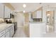 Kitchen with white cabinetry, stainless steel appliances, and tiled backsplash at 10304 Rainbow Oaks Dr, Hudson, FL 34667