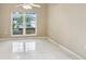 Bright living room with neutral paint, tile flooring and a large window at 10304 Rainbow Oaks Dr, Hudson, FL 34667