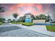 Beachwalk community entrance showcasing lush landscaping, architectural elements and a water feature at 10463 Abaco Falls Dr, Englewood, FL 34223
