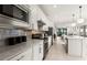 Spacious kitchen with stainless steel appliances, bar seating, and open floor plan for easy entertaining at 10463 Abaco Falls Dr, Englewood, FL 34223